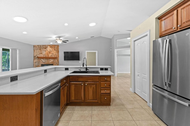 kitchen featuring lofted ceiling, sink, light tile patterned floors, ceiling fan, and stainless steel appliances