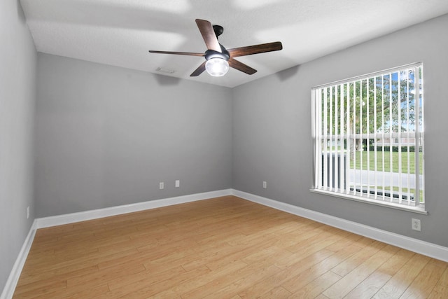 spare room featuring ceiling fan and light hardwood / wood-style floors