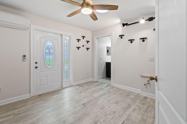 foyer entrance featuring electric panel, a wall unit AC, ceiling fan, and light wood-type flooring