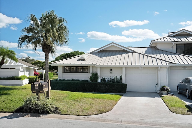 view of front facade with a garage and a front yard