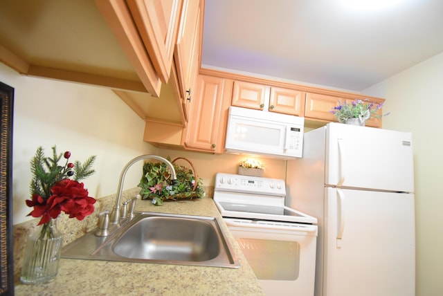 kitchen featuring white appliances, sink, and light brown cabinets