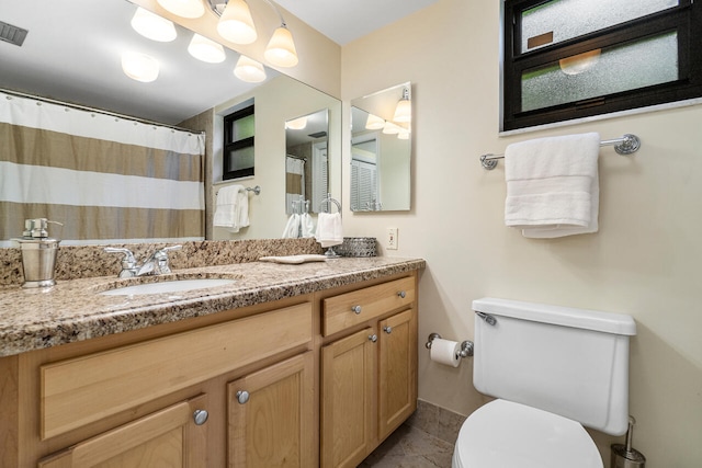 bathroom with vanity, tile patterned floors, and toilet