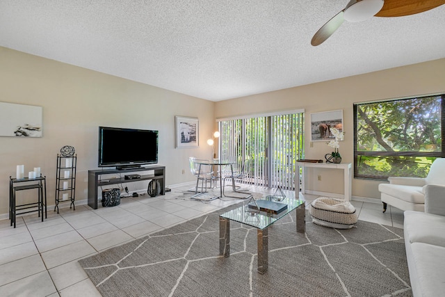 tiled living room with ceiling fan and a textured ceiling