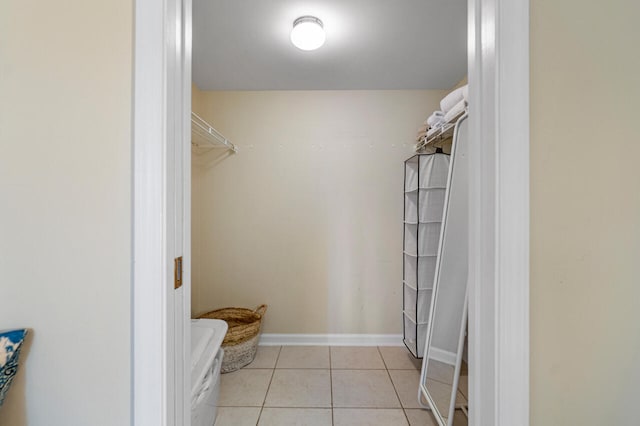 spacious closet with light tile patterned floors