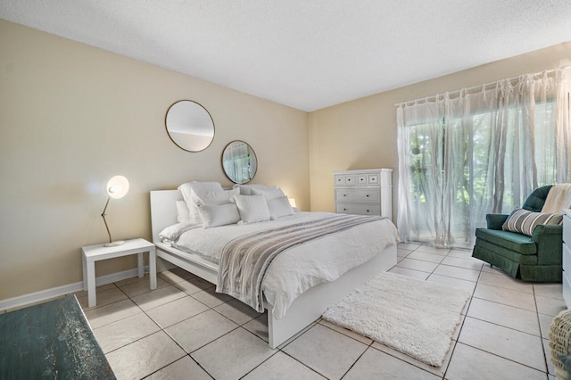 tiled bedroom featuring a textured ceiling