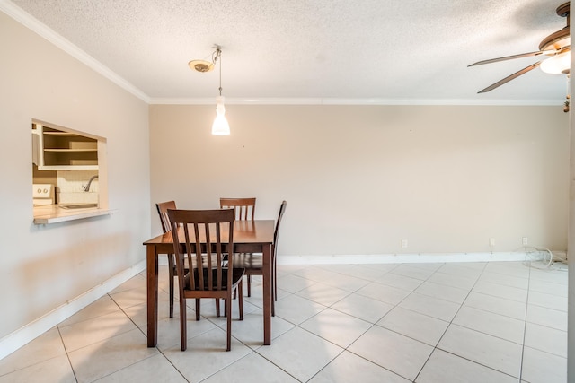 dining room featuring sink, ornamental molding, light tile patterned floors, ceiling fan, and a textured ceiling