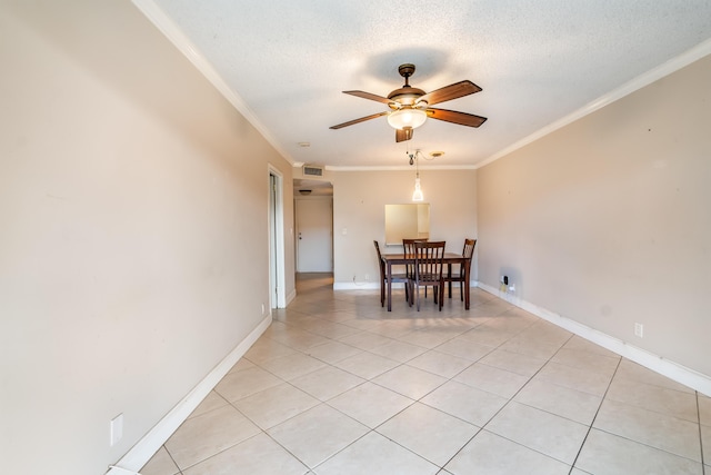 unfurnished dining area with crown molding, light tile patterned flooring, a textured ceiling, and ceiling fan