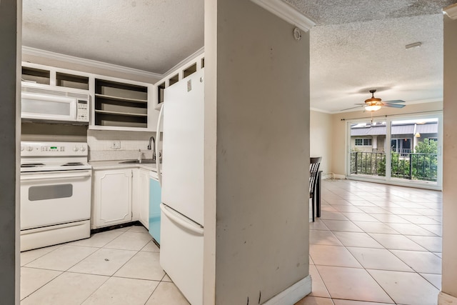 kitchen featuring sink, white appliances, a textured ceiling, white cabinets, and light tile patterned flooring