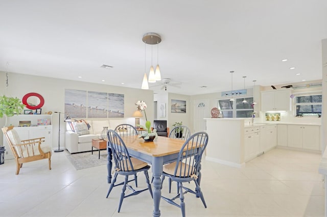 tiled dining space featuring sink and ceiling fan