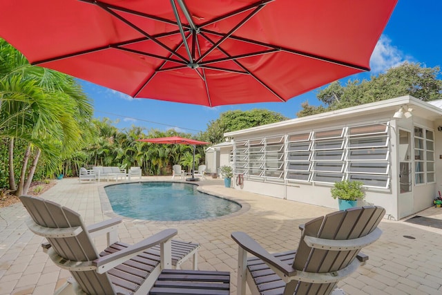 view of swimming pool with a patio area