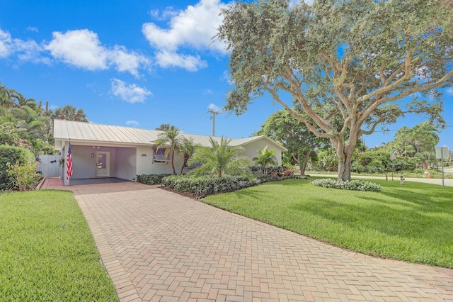 single story home featuring a carport and a front lawn