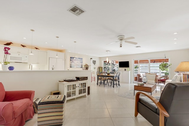 living room with ceiling fan and light tile patterned floors