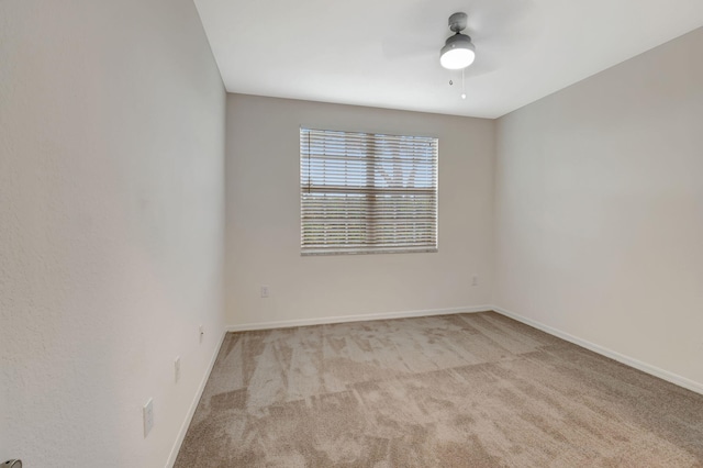 empty room with light colored carpet and ceiling fan