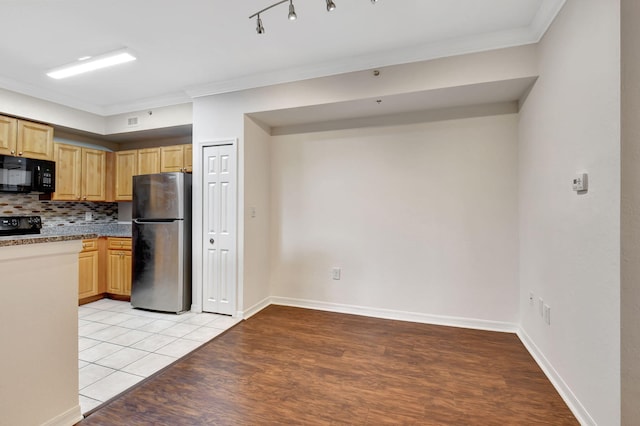 kitchen with light tile patterned flooring, light brown cabinets, stainless steel refrigerator, ornamental molding, and decorative backsplash