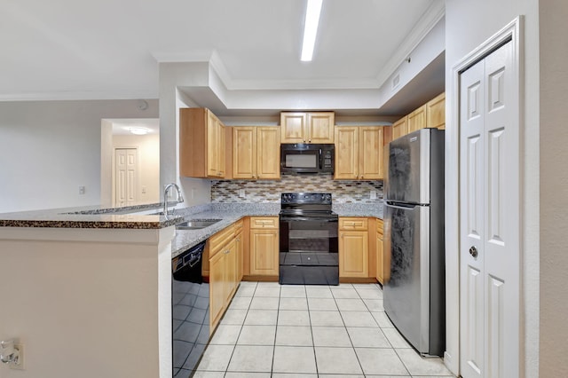 kitchen featuring sink, light tile patterned floors, dark stone countertops, kitchen peninsula, and black appliances