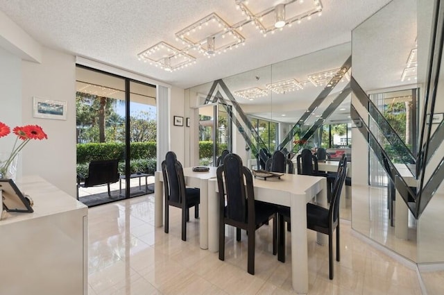 dining room featuring expansive windows and a textured ceiling