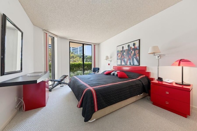 carpeted bedroom featuring floor to ceiling windows and a textured ceiling