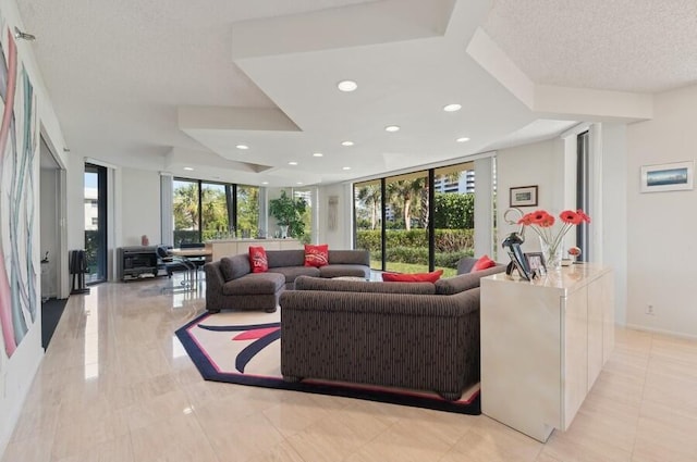 living room featuring expansive windows, a textured ceiling, and a wealth of natural light