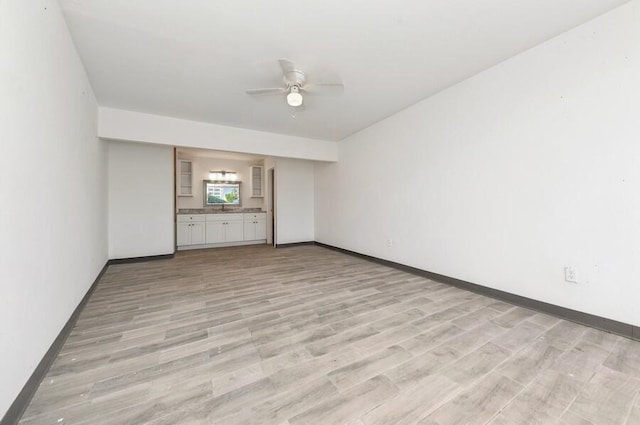 unfurnished room featuring ceiling fan and light wood-type flooring