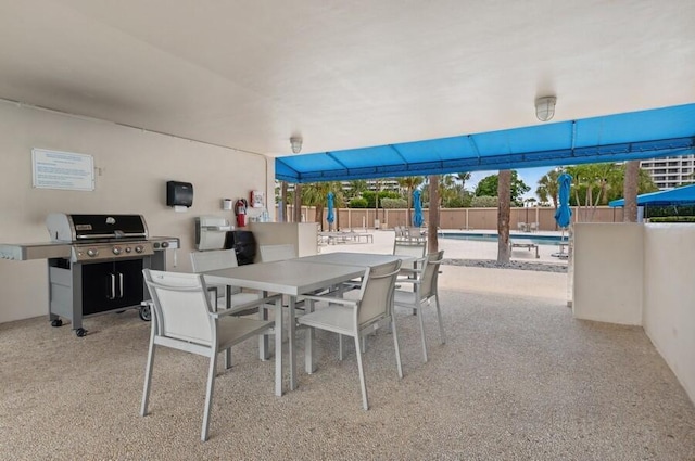 view of patio / terrace with a grill and a community pool