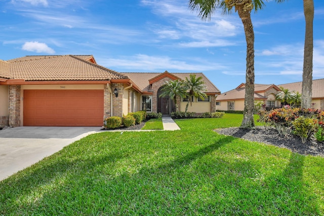 view of front of property featuring a garage and a front lawn