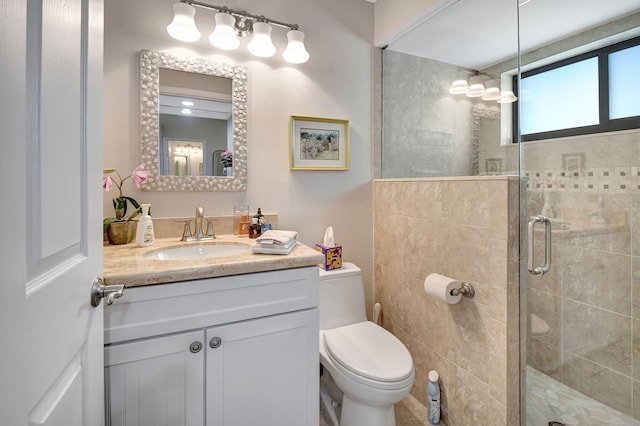 bathroom featuring vanity, toilet, and walk in shower