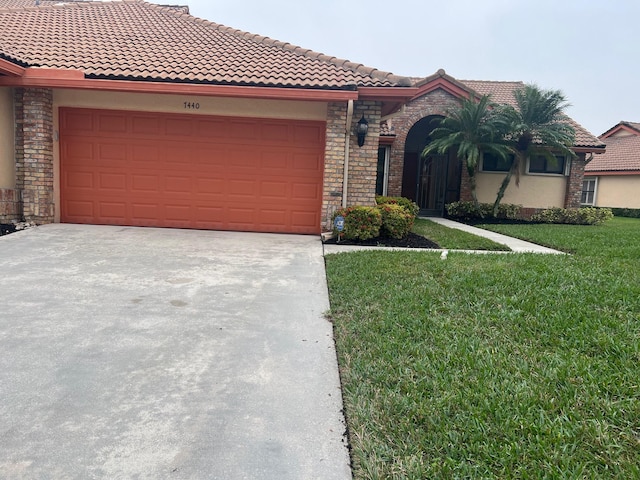 view of front of home featuring a garage and a front lawn