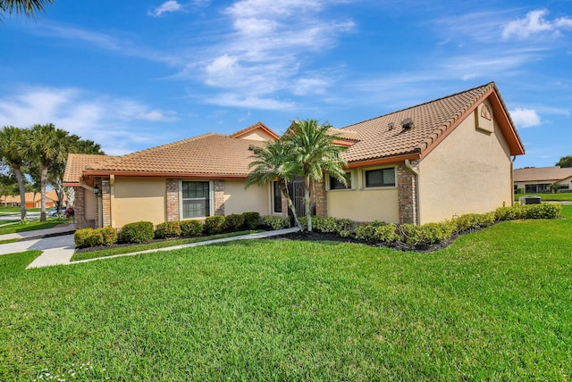 mediterranean / spanish-style home with a front lawn