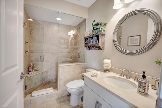 bathroom featuring tile patterned floors, vanity, toilet, and an enclosed shower