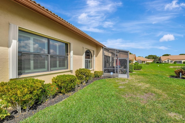 view of yard featuring a sunroom