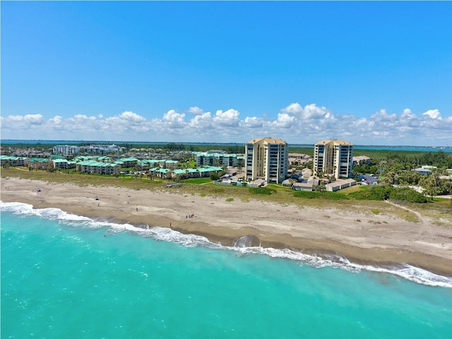 bird's eye view featuring a view of the beach and a water view