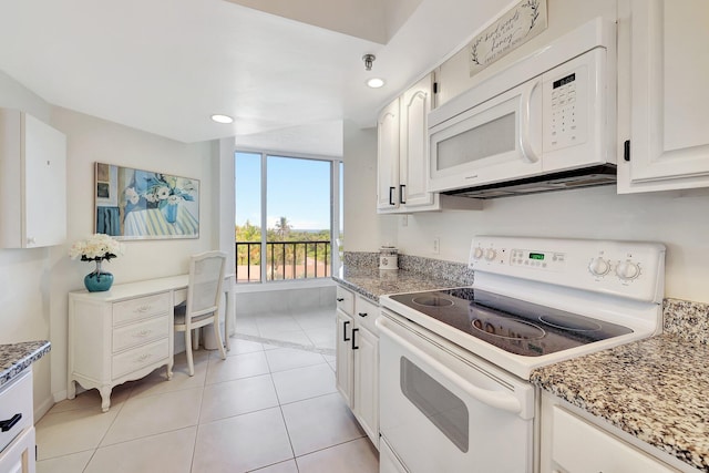 kitchen featuring light tile patterned floors, white appliances, light stone countertops, and white cabinets