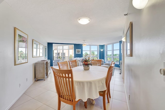 tiled dining room with ceiling fan and a textured ceiling