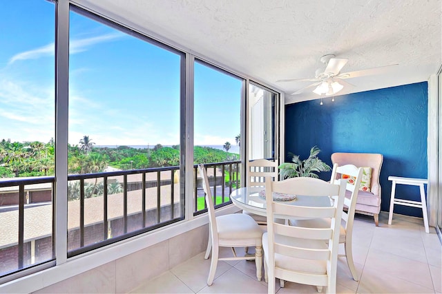 sunroom featuring ceiling fan