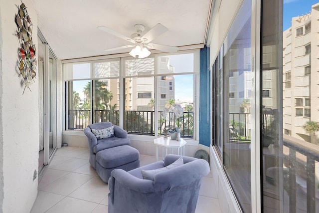 sunroom / solarium featuring ceiling fan