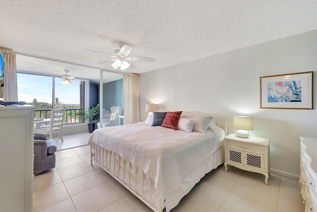 tiled bedroom featuring ceiling fan, access to exterior, and a textured ceiling