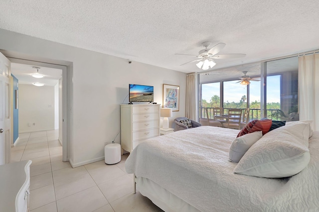 bedroom with light tile patterned floors, a textured ceiling, ceiling fan, and access to exterior