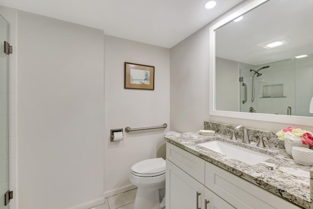 bathroom with tile patterned floors, toilet, a shower with shower door, and vanity