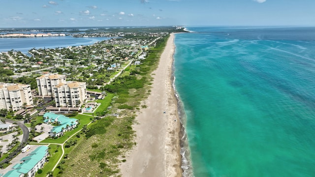 birds eye view of property featuring a water view and a beach view