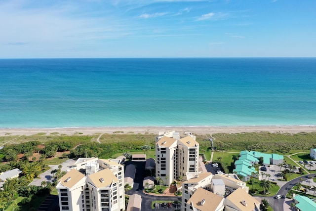 birds eye view of property with a water view and a view of the beach