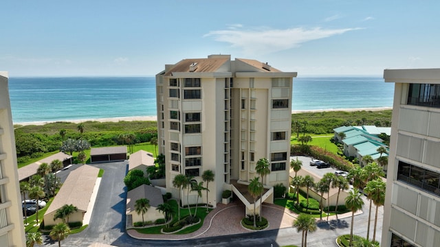 exterior space featuring a water view and a view of the beach