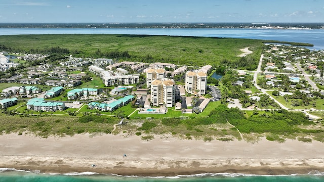 drone / aerial view featuring a beach view and a water view