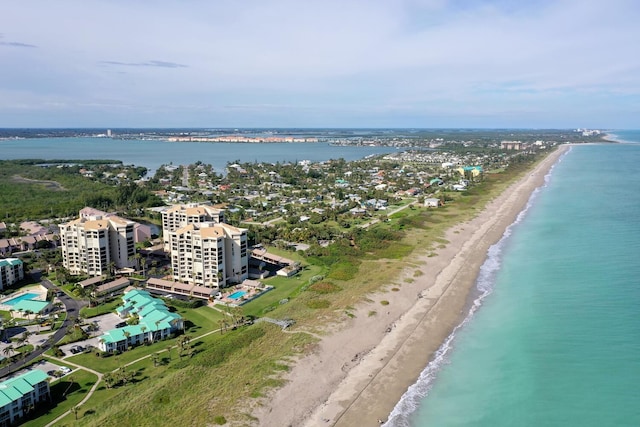 drone / aerial view featuring a view of the beach and a water view