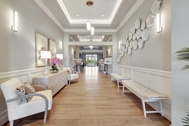 corridor featuring ornamental molding and a raised ceiling