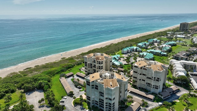 drone / aerial view with a water view and a view of the beach