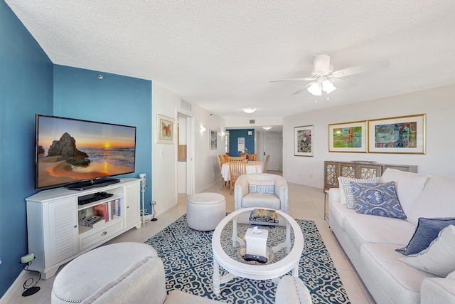 tiled living room featuring ceiling fan and a textured ceiling