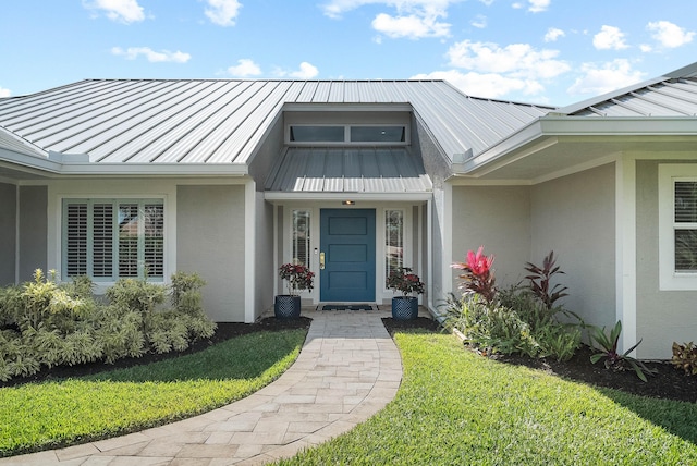 property entrance with a lawn