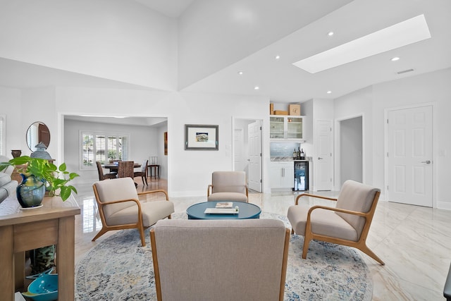 living room featuring beverage cooler and a skylight