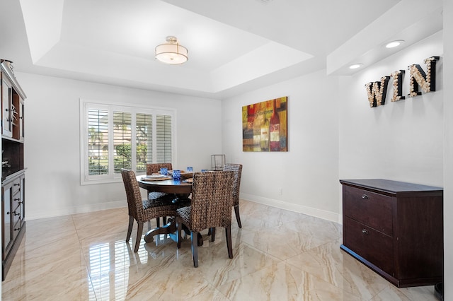 dining room with a tray ceiling