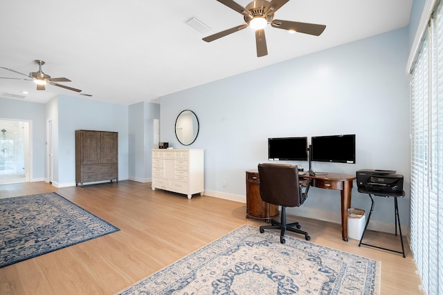 home office with ceiling fan and light hardwood / wood-style floors